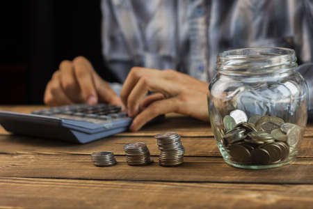 man calculating monthly savings. High quality beautiful photo conceptの写真素材