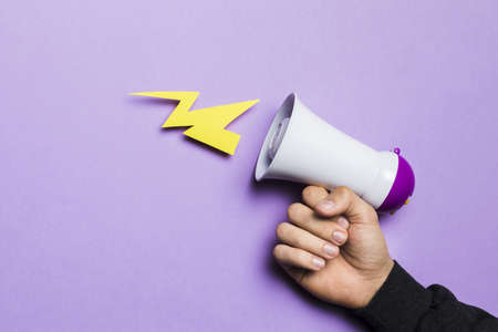 woman s hand showing power thunder with megaphone. High quality and resolution beautiful photo conceptの写真素材