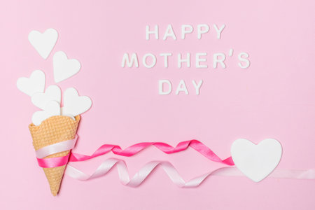 paper hearts waffle canes near happy mothers day titleの写真素材