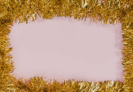 golden tinsel frame with pink background. High quality and resolution beautiful photo conceptの写真素材