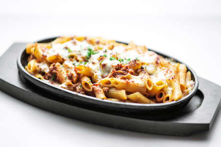 oven baked fresh pasta penne bolognese and mozzarella cheese dishの写真素材