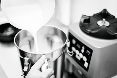 making gelato ice cream with modern equipment in kitchen interior