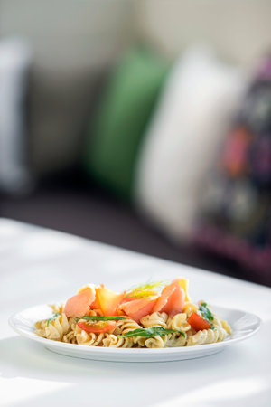 smoked salmon tomato and herb cream pasta saladの写真素材