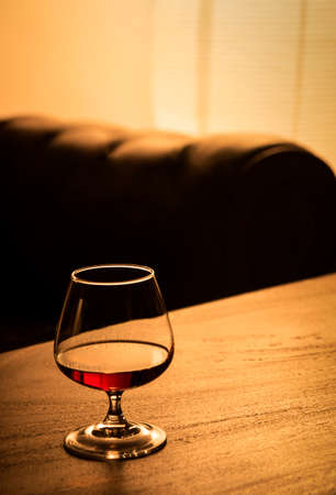 glass of french cognac brandy on cozy bar table detailの写真素材