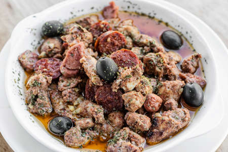 pica pau portuguese spicy sauce pork and sausage tapas snackの写真素材