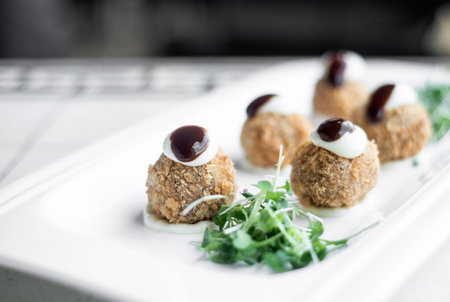 gourmet organic scotch quail eggs starter snack on tableの写真素材