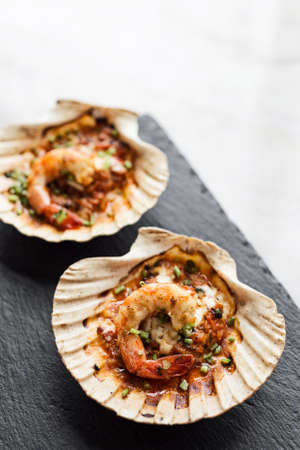 baked king prawns in spicy tomato and herb sauceの写真素材