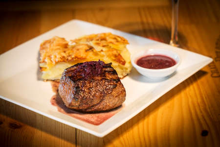 grilled steak with potato onion and cheese bakeの写真素材