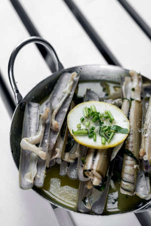 razor clams sauteed with garlic butter white wine in spainの写真素材