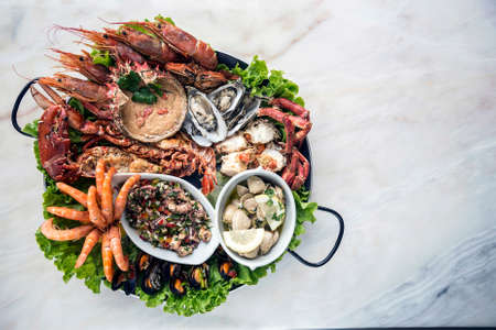 mixed fresh seafood selection gourmet set platter meal on tableの写真素材