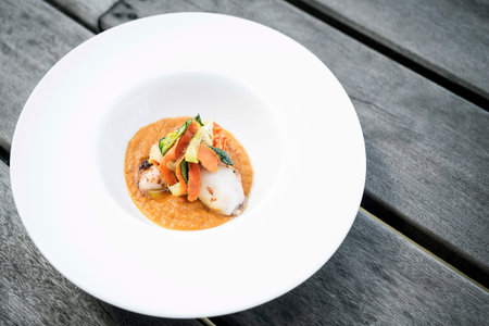 gourmet stuffed squid with vegetables in pumpkin curry puree