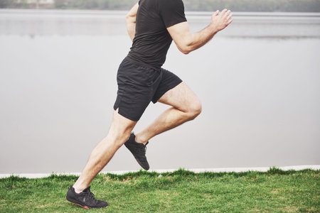 The bearded young man is engaged in outdoor sports