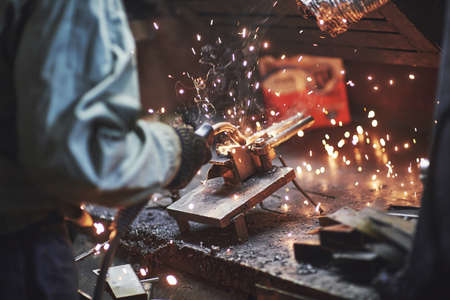 Industrial factory weld worker. Welding or welder master weld the steelの写真素材