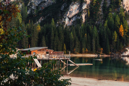 Trees and hill of the mountain. Touristic place with wooden building and pear. People on the coast