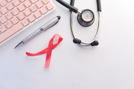 Red ribbon HIV, and stethoscope on white background