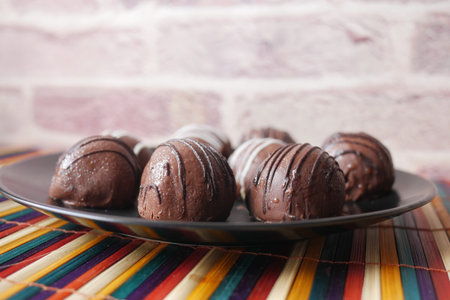 dark chocolate on a plate on pink background .