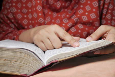Muslim women's hand reading quran at night .