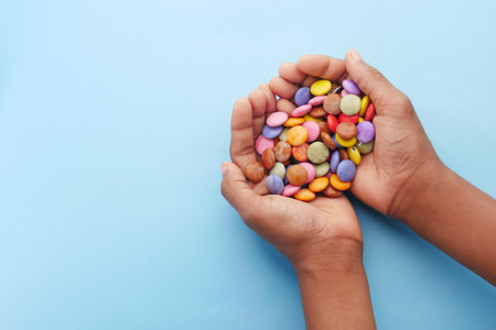 child boy picking multi-colored sweet candies top view.の写真素材