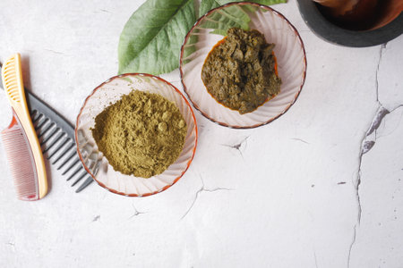 The wooden bowl with rehydrated henna on table .の写真素材