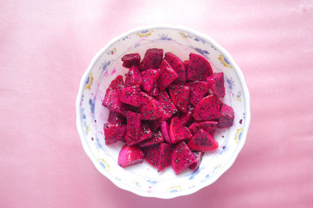 slice of dragon fruit on in a bowl on pinkの写真素材