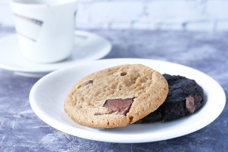 Close up of cookies and tea on table .