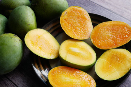 yellow ripe cut mango in a bowl top down.