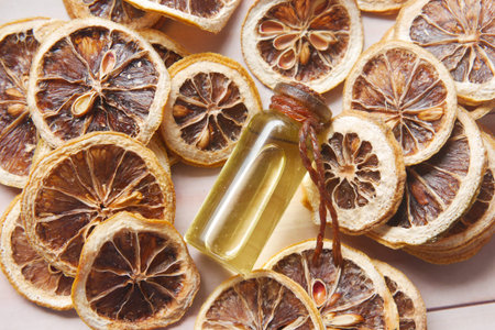 essential citrus oil, dried lemon and spice on tableの写真素材