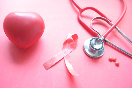 Red ribbon HIV, and stethoscope on red backgroundの写真素材