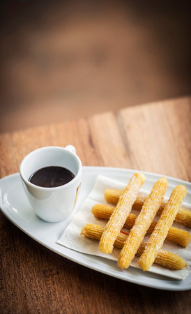 churros and chocolate spanish donuts pastry doughnuts with sauce breakfast snackの写真素材