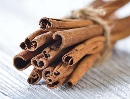 Cinnamon on white woodの写真素材