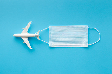 flat lay medical mask with airplane figurineの写真素材