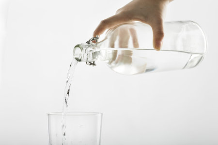 pouring water from bottle into glass . Resolution and high quality beautiful photo