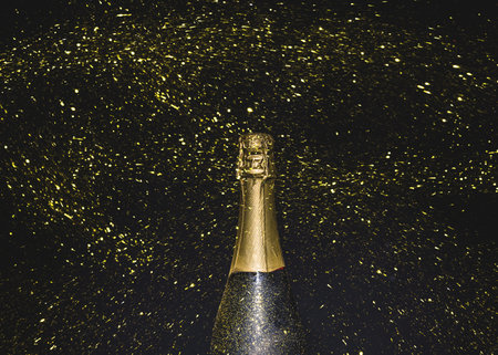 bottle champagne flying golden glitters. Resolution and high quality beautiful photoの写真素材