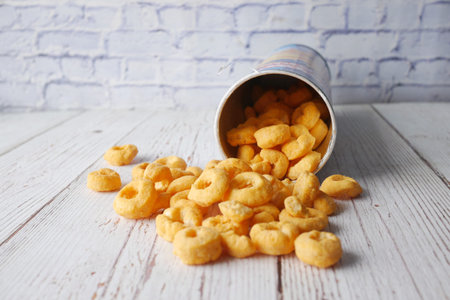 tasty potato chips spilling from a container .