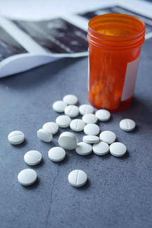 white color medical pills spilling on pink ,
