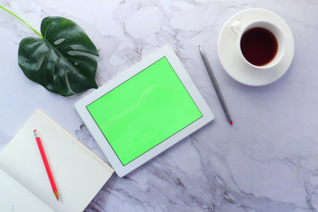 top view of digital tablet with office suppliers on table.の写真素材