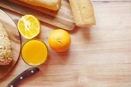 glass of orange juice and brown bread on table ,の写真素材