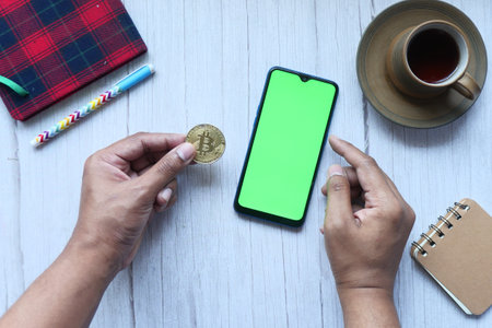 dhaka bangladesh 23 may 2021, holding golden bitcoins with copy space .の写真素材