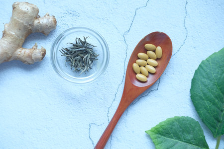 herbal medicine on spoon and herbs on tableの写真素材