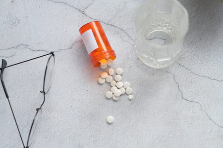 white color medical pills spilling on table .