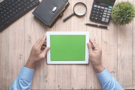 Flat composition of digital tablet and office stationary on wooden background .の写真素材