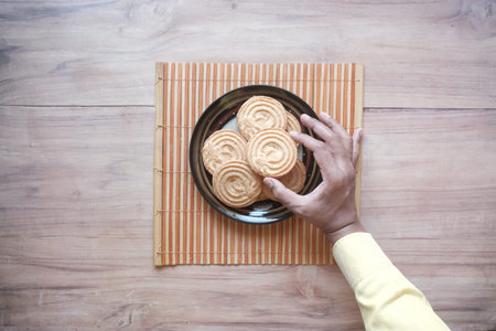stack of chocolate cookies on wooden background.