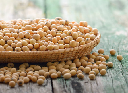 Soy beans in a basket on woodenの写真素材