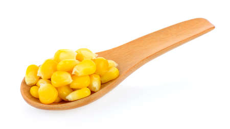 corn seeds in wood spoon on white backgroundの写真素材