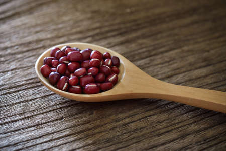 azuki beans in wood spoon on tableの写真素材