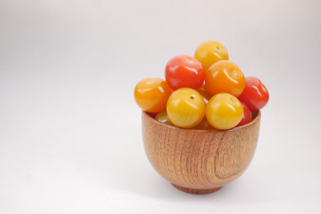 red color cherry tomato on heart shape plate on table .の写真素材