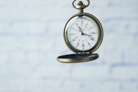 old vintage clock against while wall .の写真素材