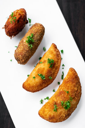 portuguese traditional mixed fried tapas snacks on plate with shrimp rissole, beef croquette and cod fish nuggetの写真素材