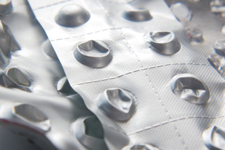 Close up of pills of blister pack on table .