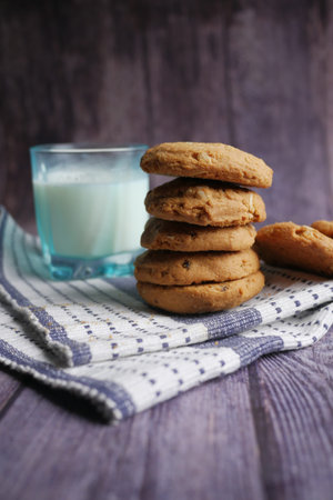 stack of chocolate cookies on wooden background.
